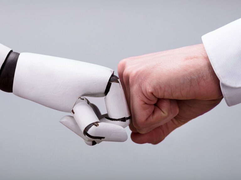 Robot And Human Hand Making Fist Bump