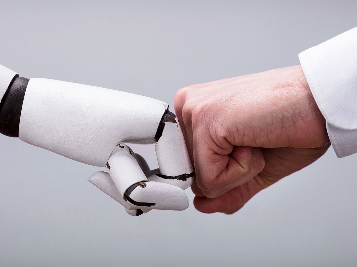 Robot And Human Hand Making Fist Bump