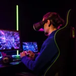 A gamer wearing a VR headset plays with a controller at a neon-lit computer setup